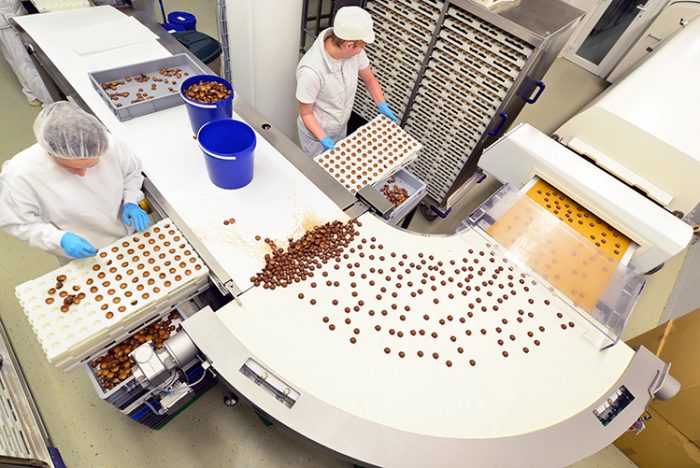 Environmental Monitoring - Food production conveyor belt with two staff checking passing product.