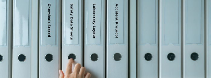 Row of ring binders containing safety information documents.